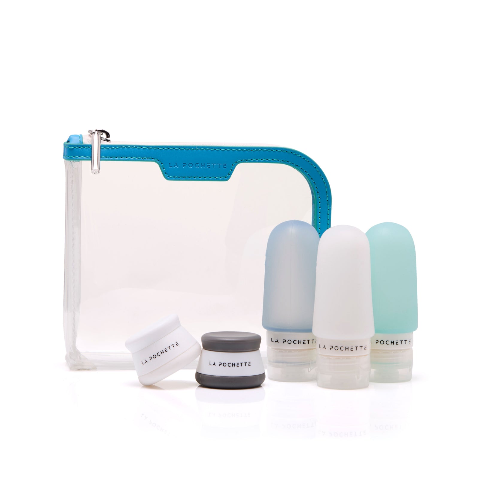 Three refillable travel bottles styled with matching travel pots and the La Pochette Anywhere Everywhere clear cosmetic pouch