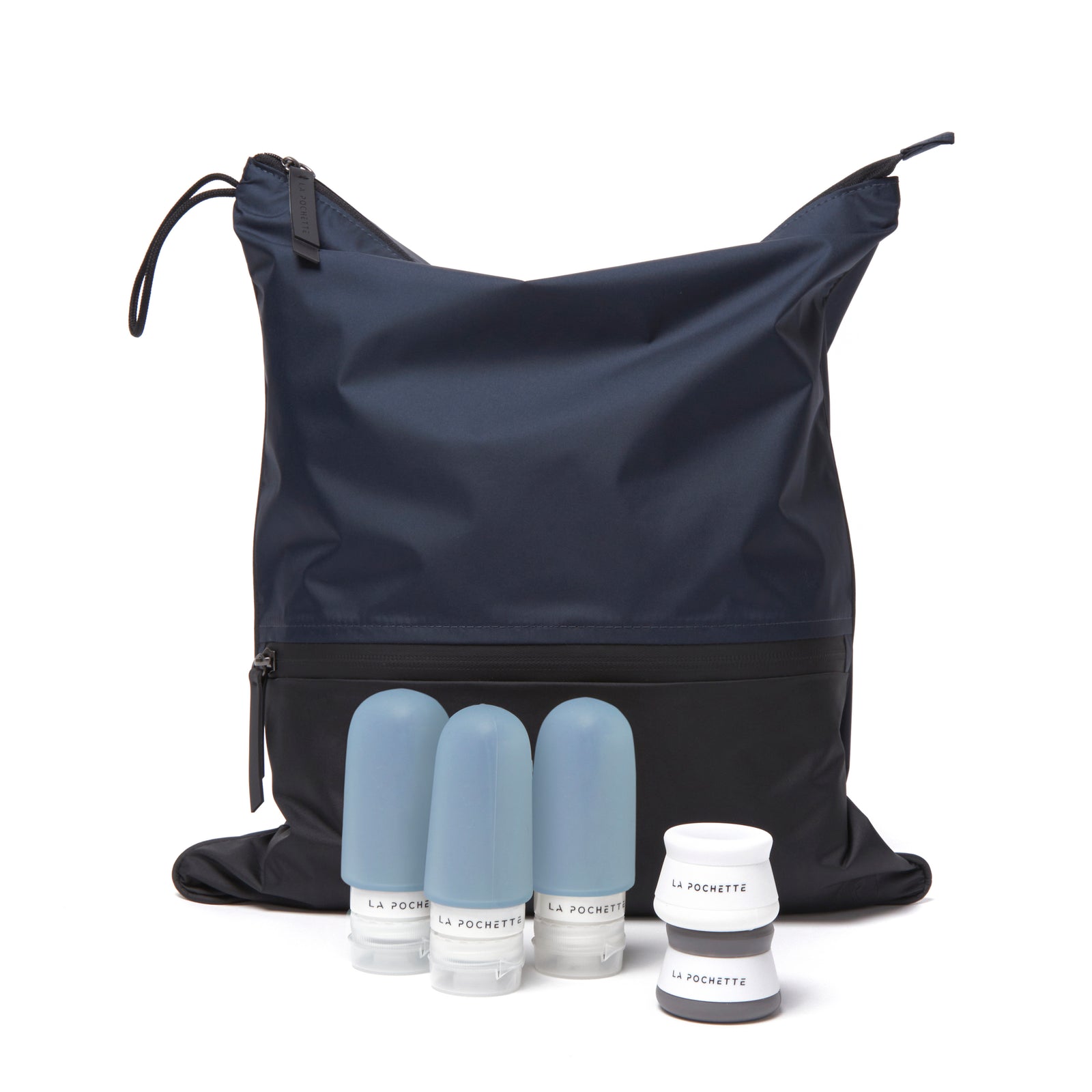 Navy blue sweat bag with three blue bottles and travel pots on a white background
