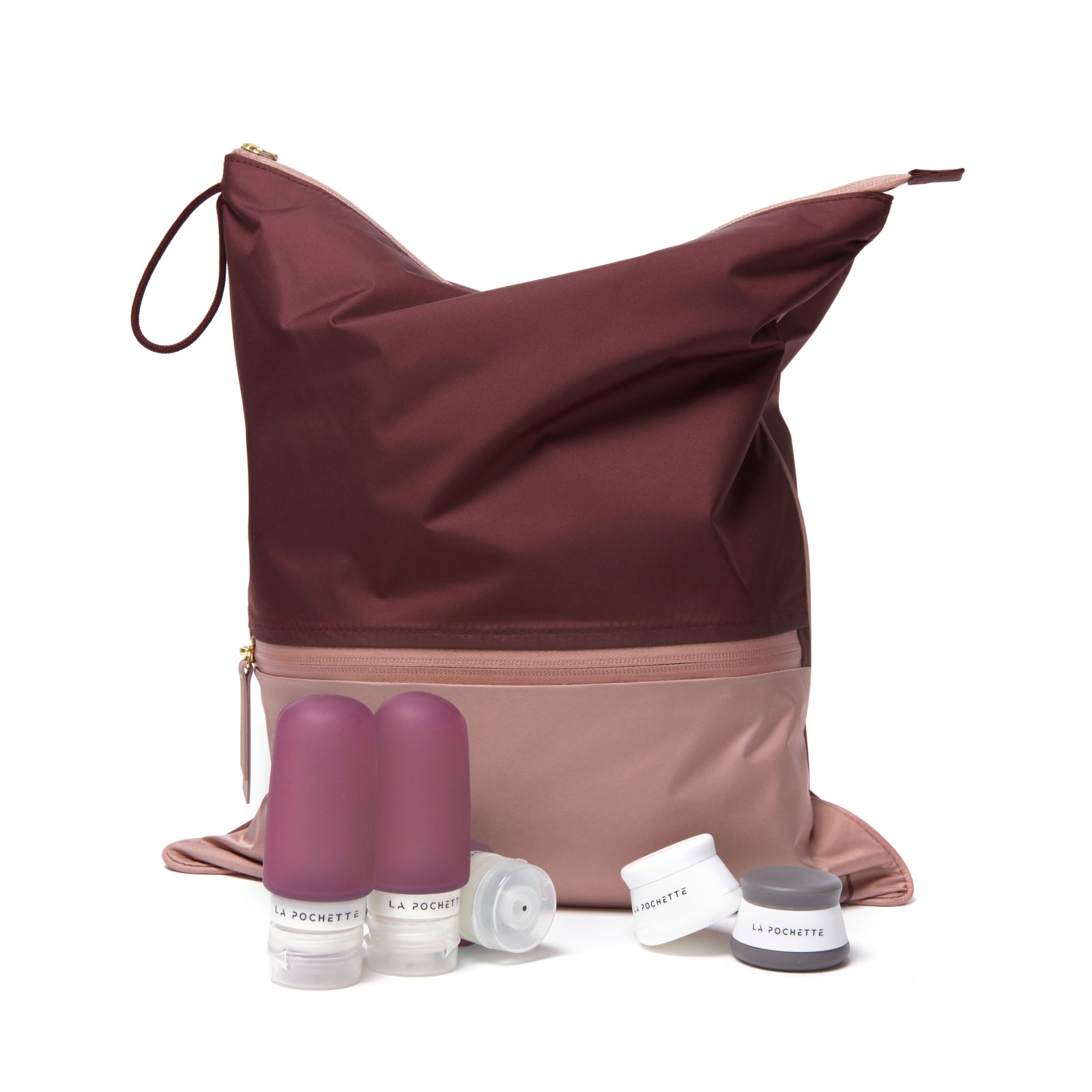 Burgundy and Pink Sweat Bag with travel bottles and pots on a white background