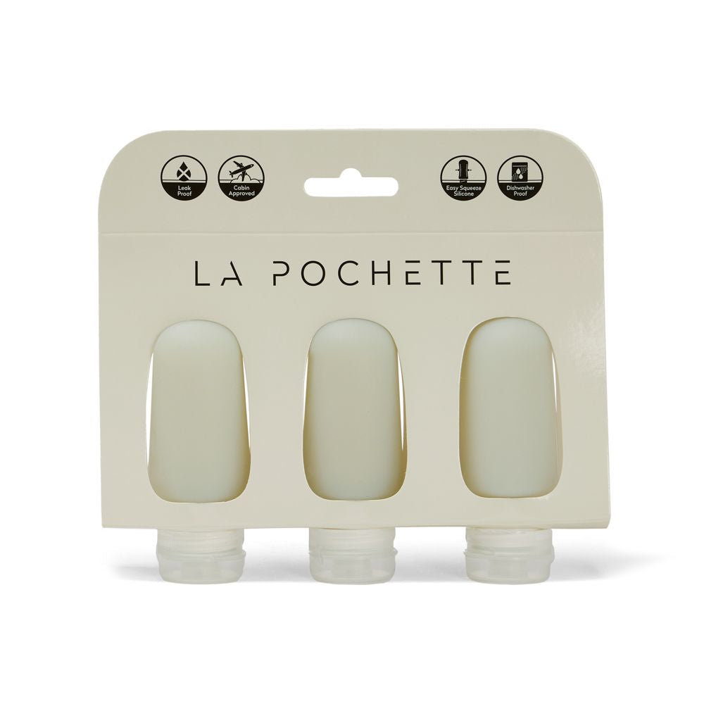 Set of three refillable silicone travel bottles, in sage green, displayed in La Pochette packaging