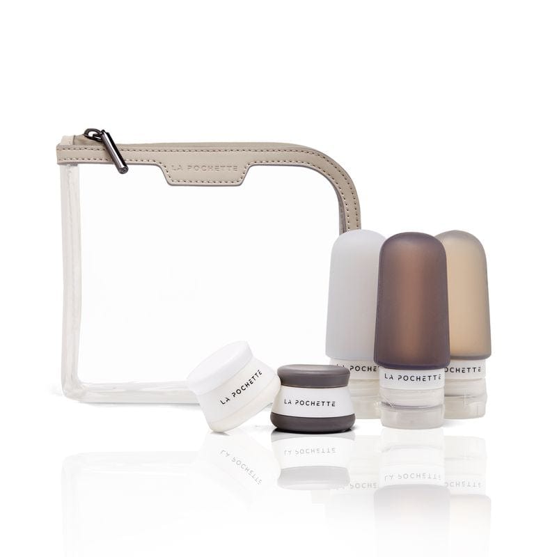 Three refillable travel bottles styled with matching travel pots and the La Pochette Anywhere Everywhere clear cosmetic pouch