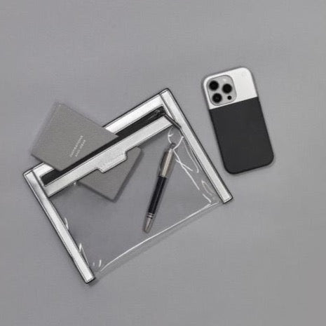 Silver and black Anywhere Everywhere Wallet with phone at the side and pen and pad inside the wallet
