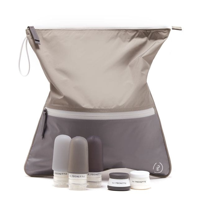 Grey and taupe la pochette antimicrobial sweat bag with travel bottles and pots. white background