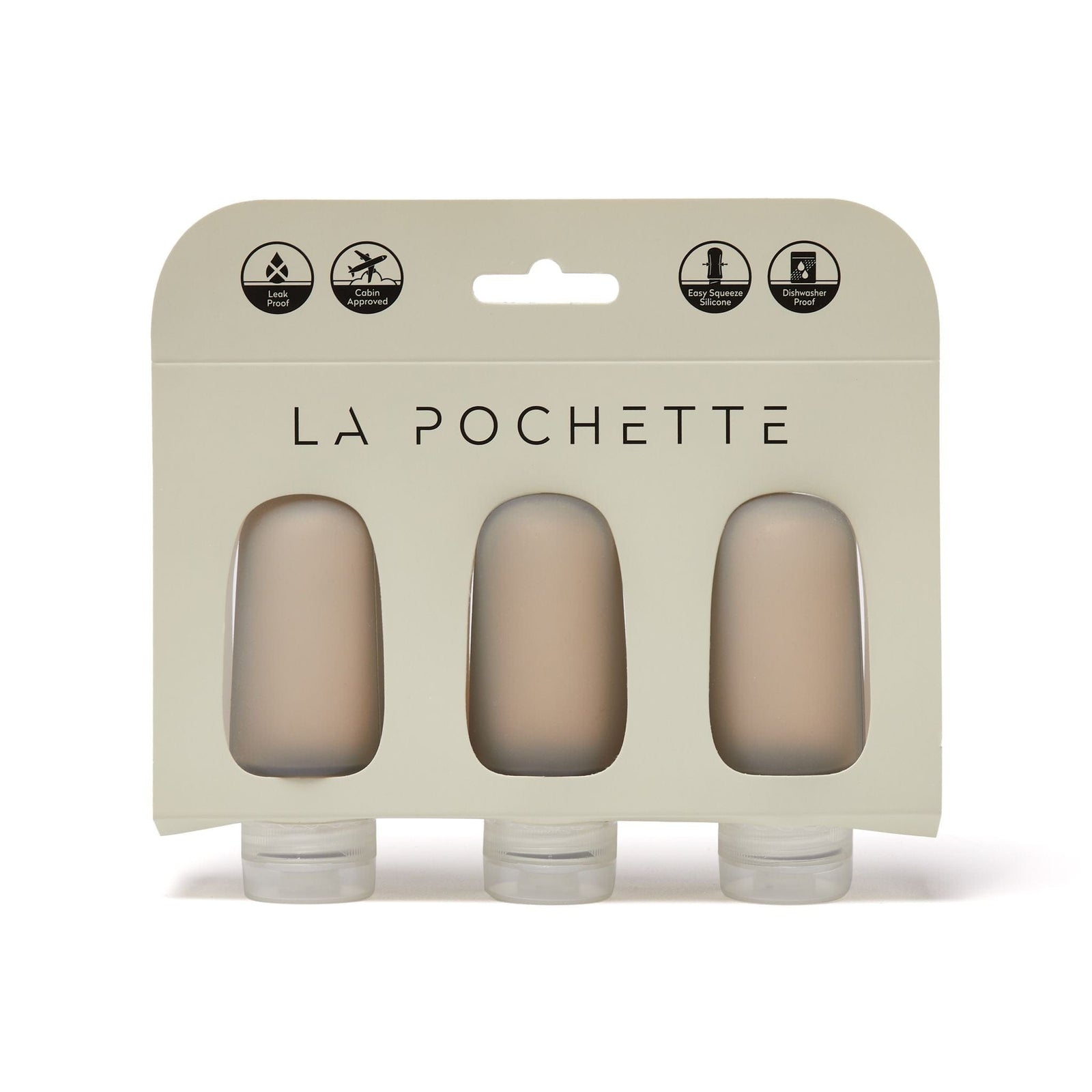 Set of three refillable silicone travel bottles, in warm beige, displayed in La Pochette packaging