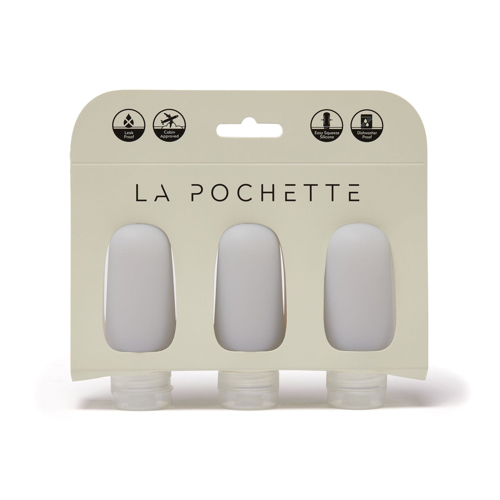Set of three refillable silicone travel bottles, in soft grey, displayed in La Pochette packaging
