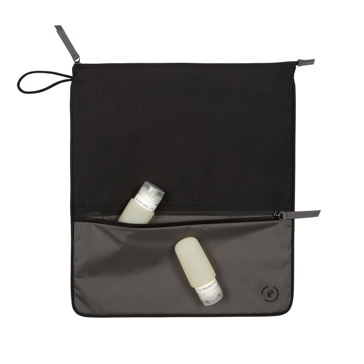 Ink Pewter Sweat Bag, shown flat with two La Pochette silicone travel bottles resting on top and in front pocket