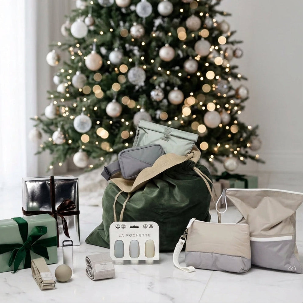 An assortment of La Pochette gifts in front of a Christmas tree 