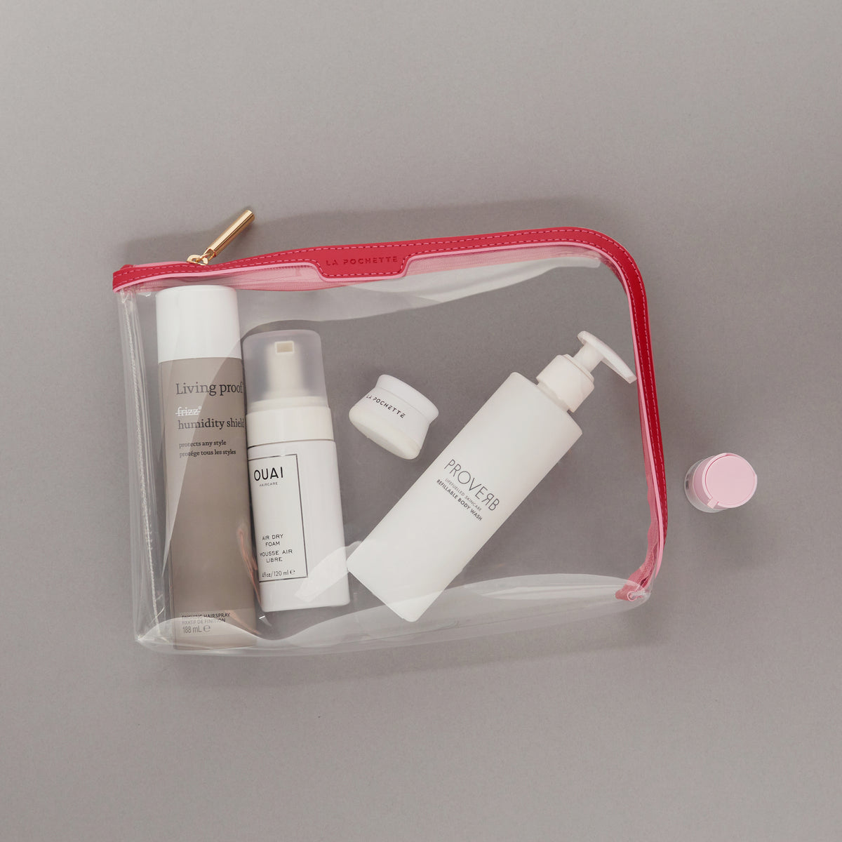 Large Anywhere Everywhere Pouch in Cashmere White colourway holding beauty products