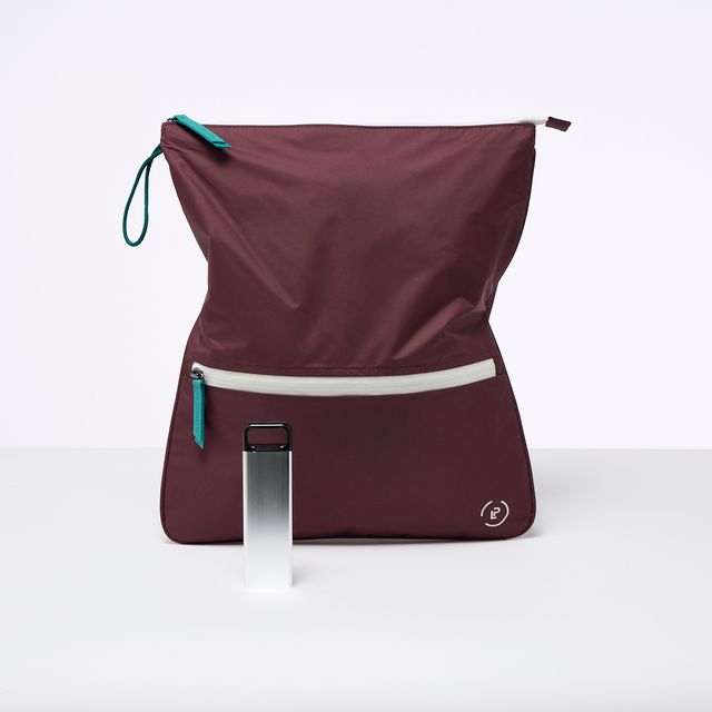A burgundy La Pochette antimicrobial Sweat Bag with white and teal trims, shown with a 3 day stainless steel supplement box. On a white background