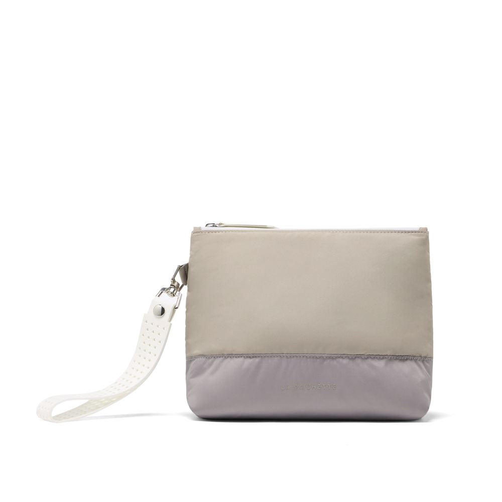 Two-tone beige and gray clutch bag with a strap on a white background