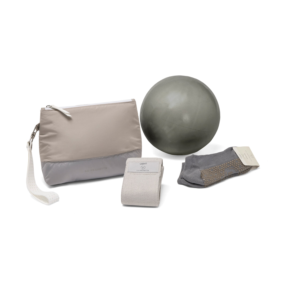 La Pochette taupe and grey Everywhere pouch together with grey La Pochette Pilates ball, resistance band, and grey grip socks. 
