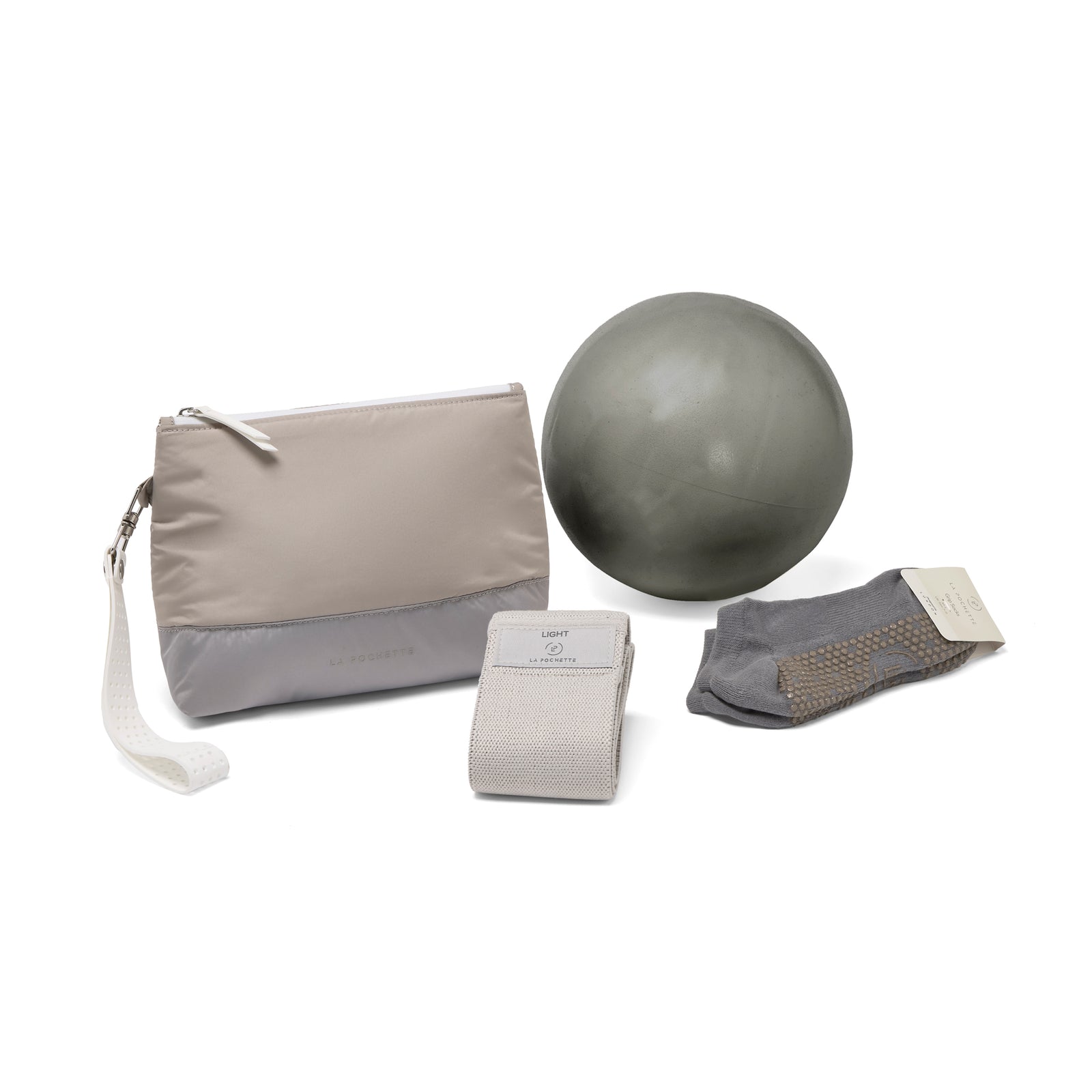 La Pochette taupe and grey Everywhere pouch together with grey La Pochette Pilates ball, resistance band, and grey grip socks. 