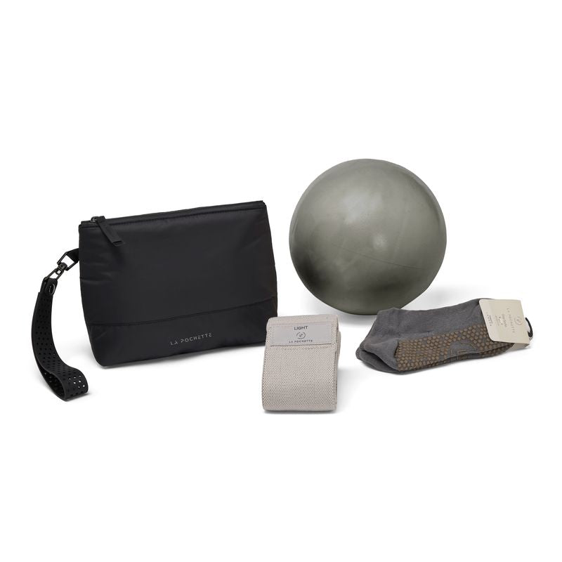 La Pochette black Everywhere pouch together with grey La Pochette Pilates ball, resistance band, and grey grip socks. 