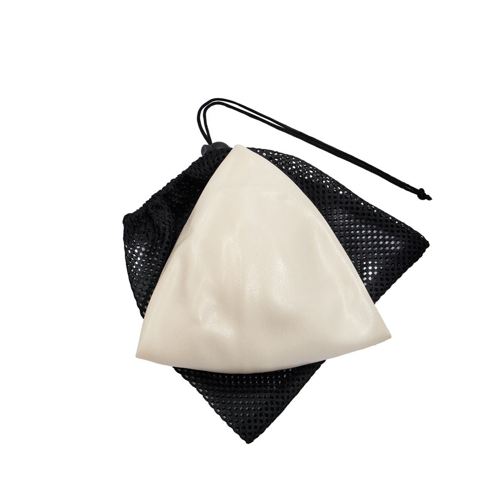 Black mesh drawstring bag with an ivory deflated pilates ball 