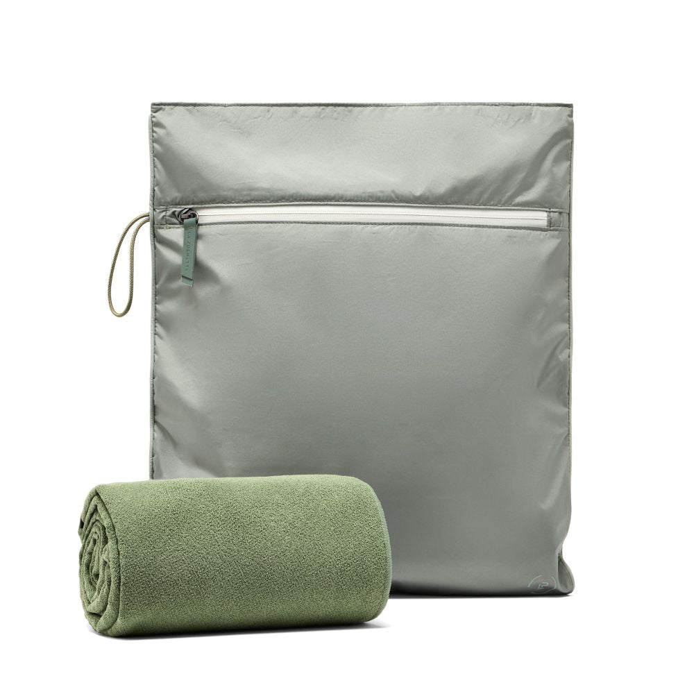 Kit bag in sage green upright, paired with a rolled up green towel