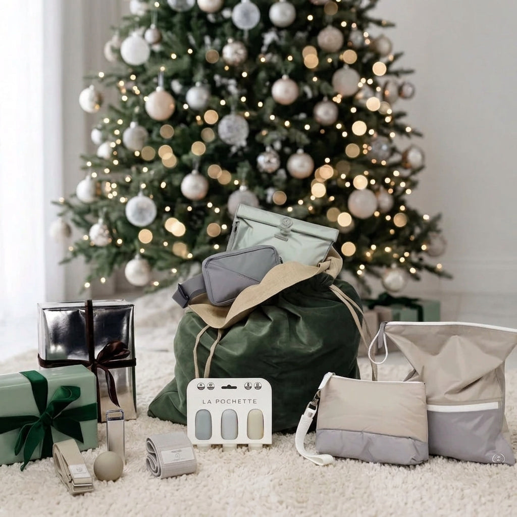 An assortment of La Pochette gifts in front of a Christmas tree 