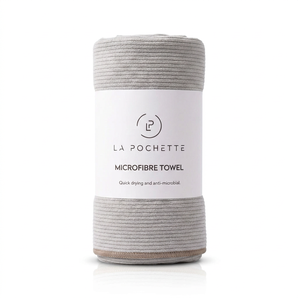 La Pochette Microfibre Grey Towel with taupe edge in card sleeve packaging with a bright white background 