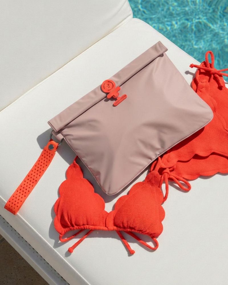 Pink Wet Bag on a sun lounger by a pool