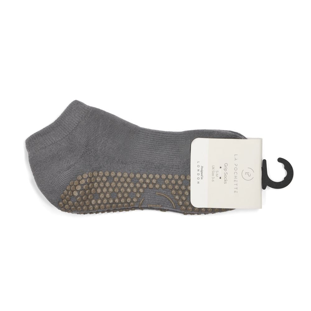 Grey grip socks in packaging on a white background