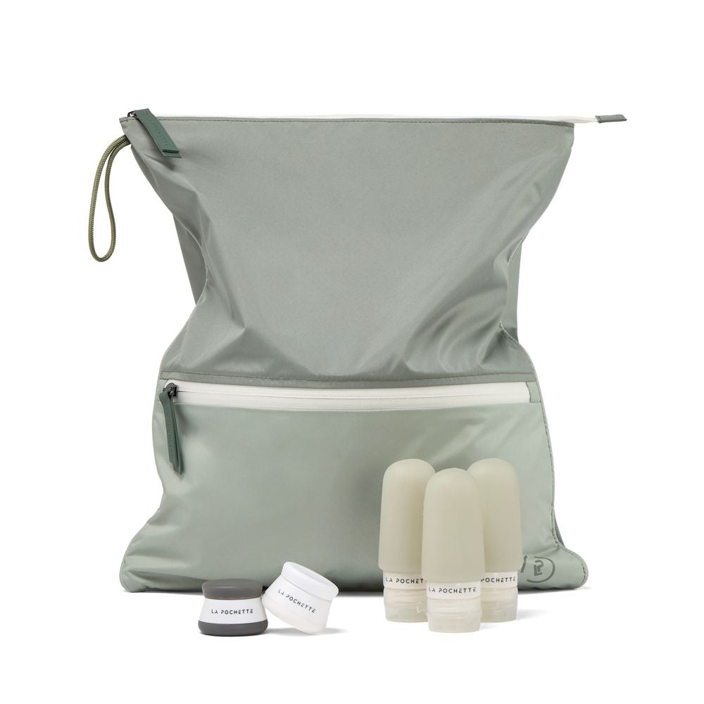 Sage Green La Pochette Sweat Bag   bag with travel Bottles and pots on a white background