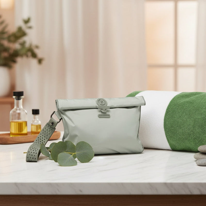 Small pale green La Pochette waterproof wet Bag with towel in a luxury spa