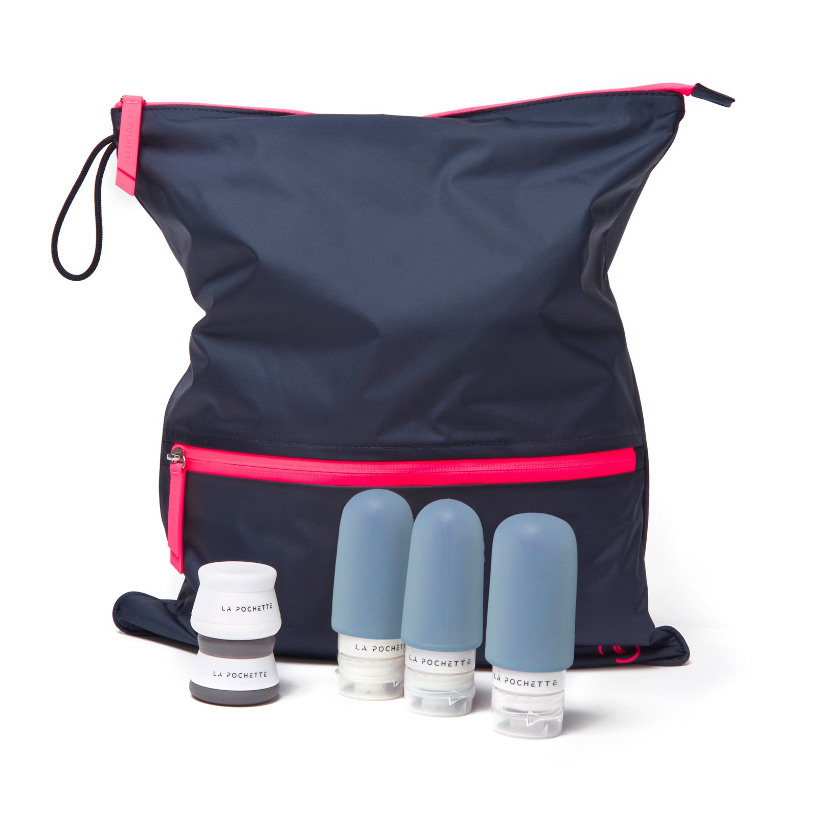 Navy and neon pink sweat bag with three travel  bottles and a white travel pot 