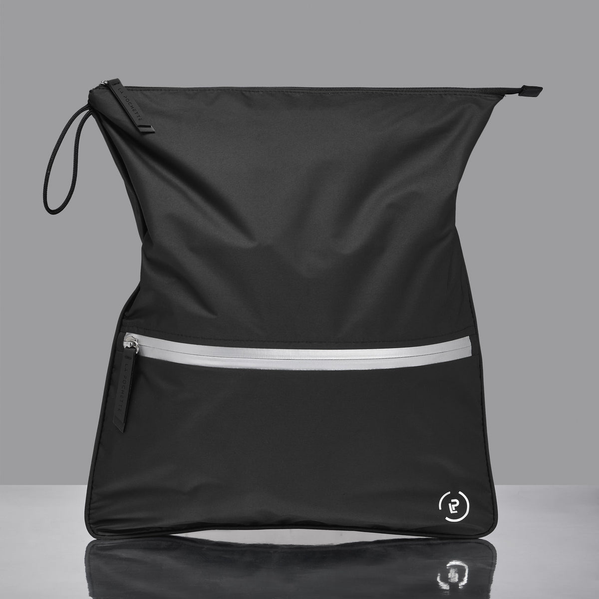 Sweat Bag in silver with black trims shown on a mirrored table