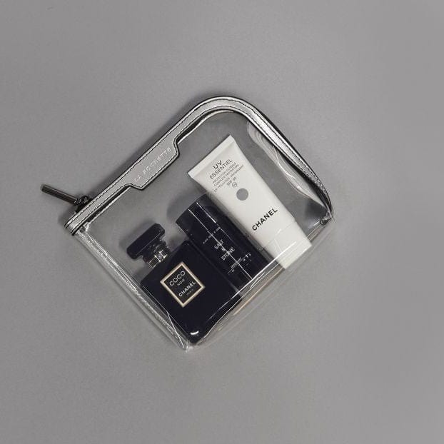 Small Anywhere Everywhere see through pouch in silver and black  showing various products inside