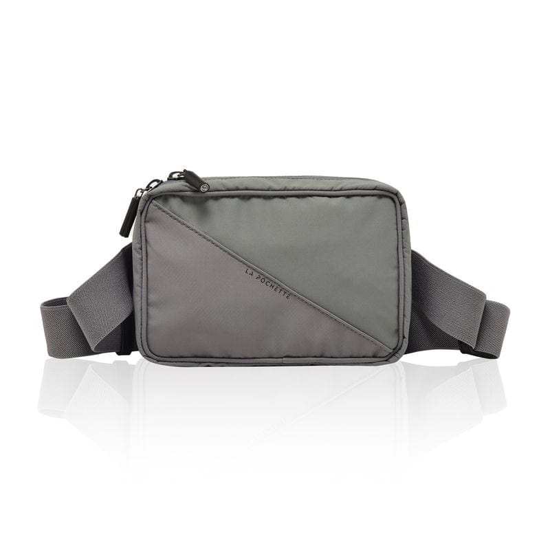 A convertible belt bag in grey and sage colours, featuring an elasticated waistband, hidden poppers, and a Fidlock V Lock fastener. The bag is  made of recycled nylon
