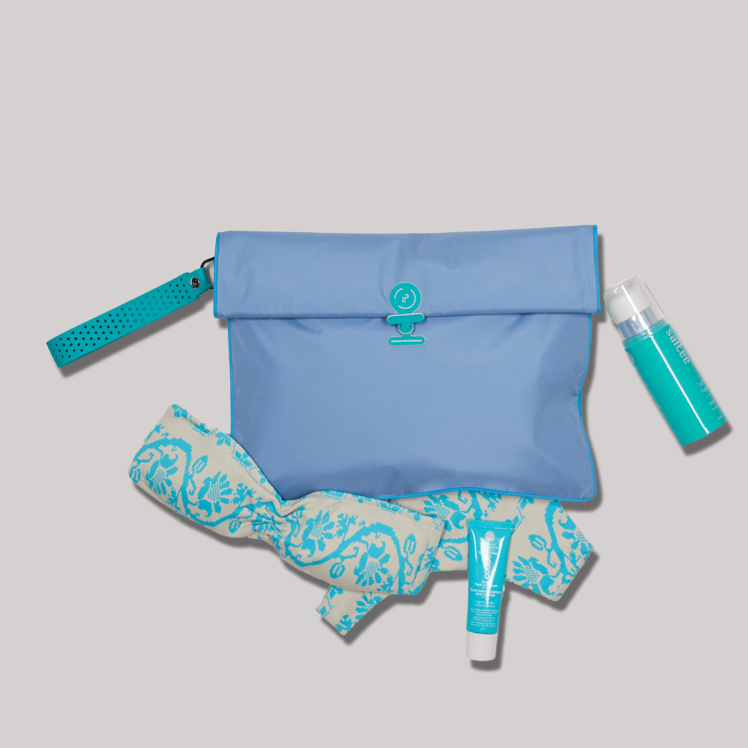 Maxi wet bag in blue and turquoise colours with a bikini and suncream