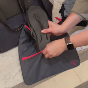 demonstration of using the sweat bag in navy and neon pink, packing gym kit into the sweat bag and flip flops into the front pocket, then putting it into a tote bag with other essentials