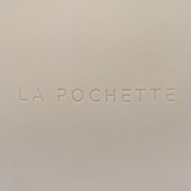A matte beige spherical massage ball with the brand name 'LA POCHETTE' embossed on the front, set against a clean white background with a soft shadow.