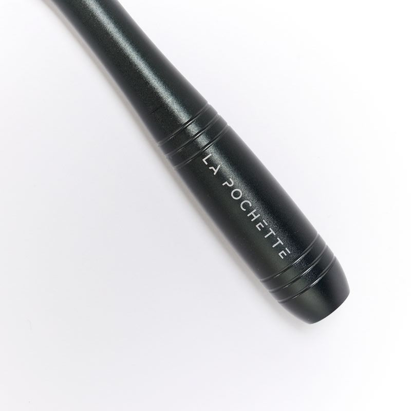 A close-up of a black skipping rope handle showing  'LA POCHETTE'  logo in white text, photographed on a clean white background.