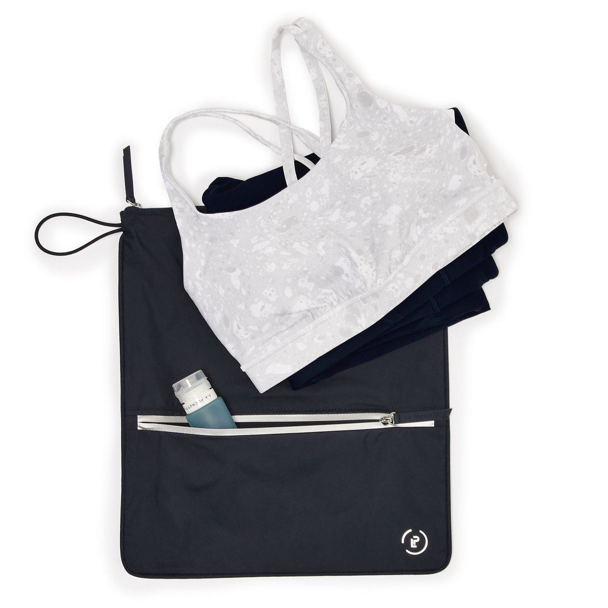 Midnight Silver Sweat bag laying flat, with front pocket open holding a travel bottle, and workout kit on top of sweat bag.