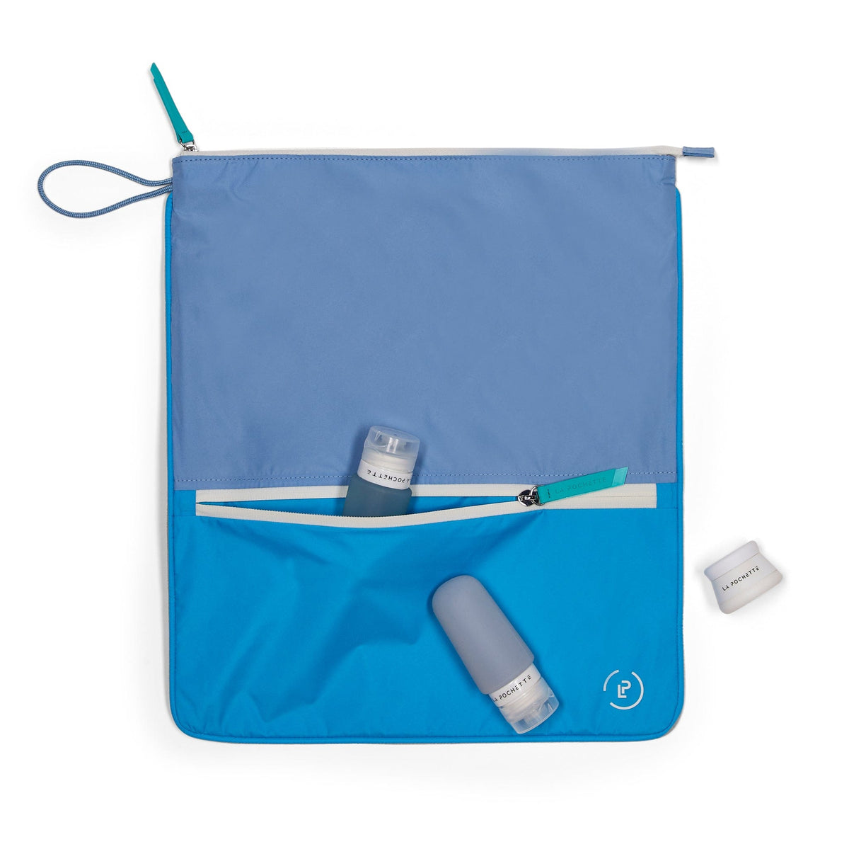 Sweat Bag in Mykonos Colour way (blue and turquoise) with La Pochette travel bottles in blue in front pocket and travel pot.