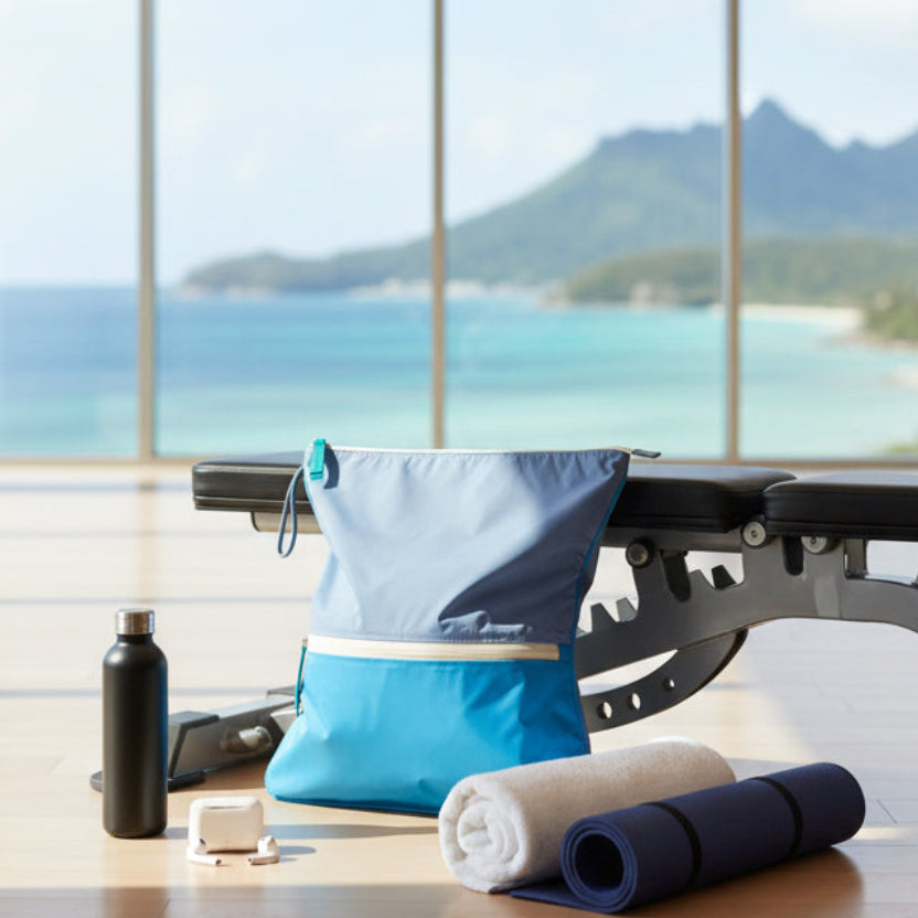 Sweat Bag in vivid blues shown in a gym environment with other gym essentials, overlooking a nice view