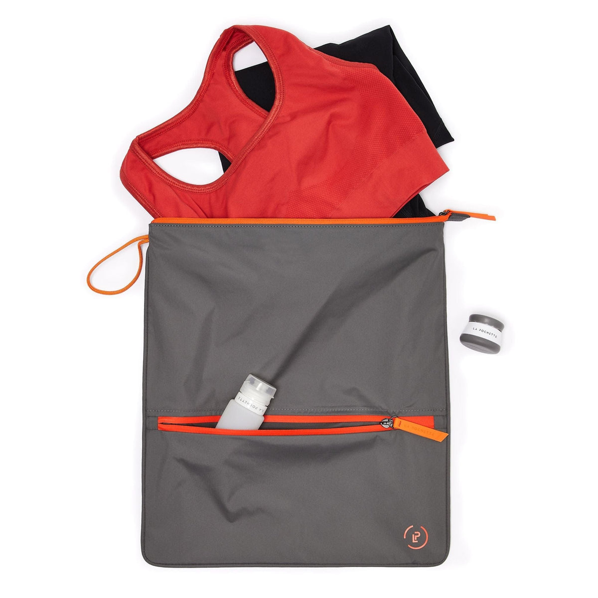 Dark grey and vivid orange Sweat Bag showing front pocket containing travel bottles and gym wear inside of the bag