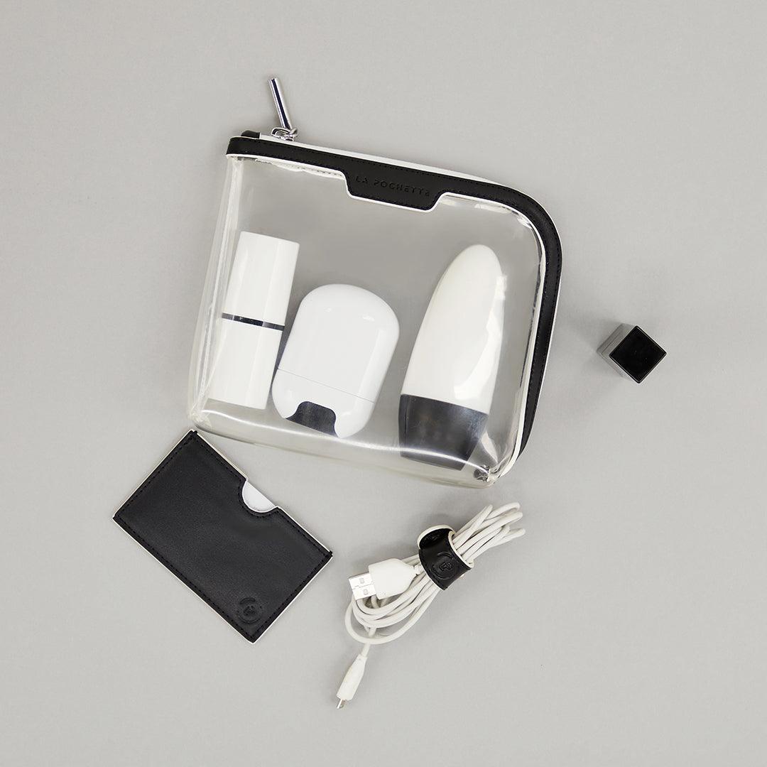 Small Anywhere Everywhere Pouch in Ink White colourway containing beauty accessories next to card wallet and cable today in Ink White colourway
