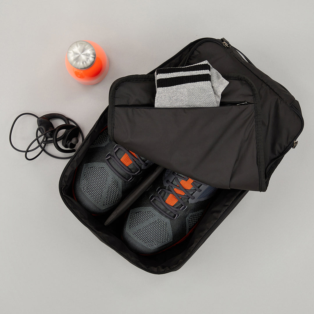 Small Shoe carry in Ink colourway unzipped showing shoes inside and socks in the inner pocket 