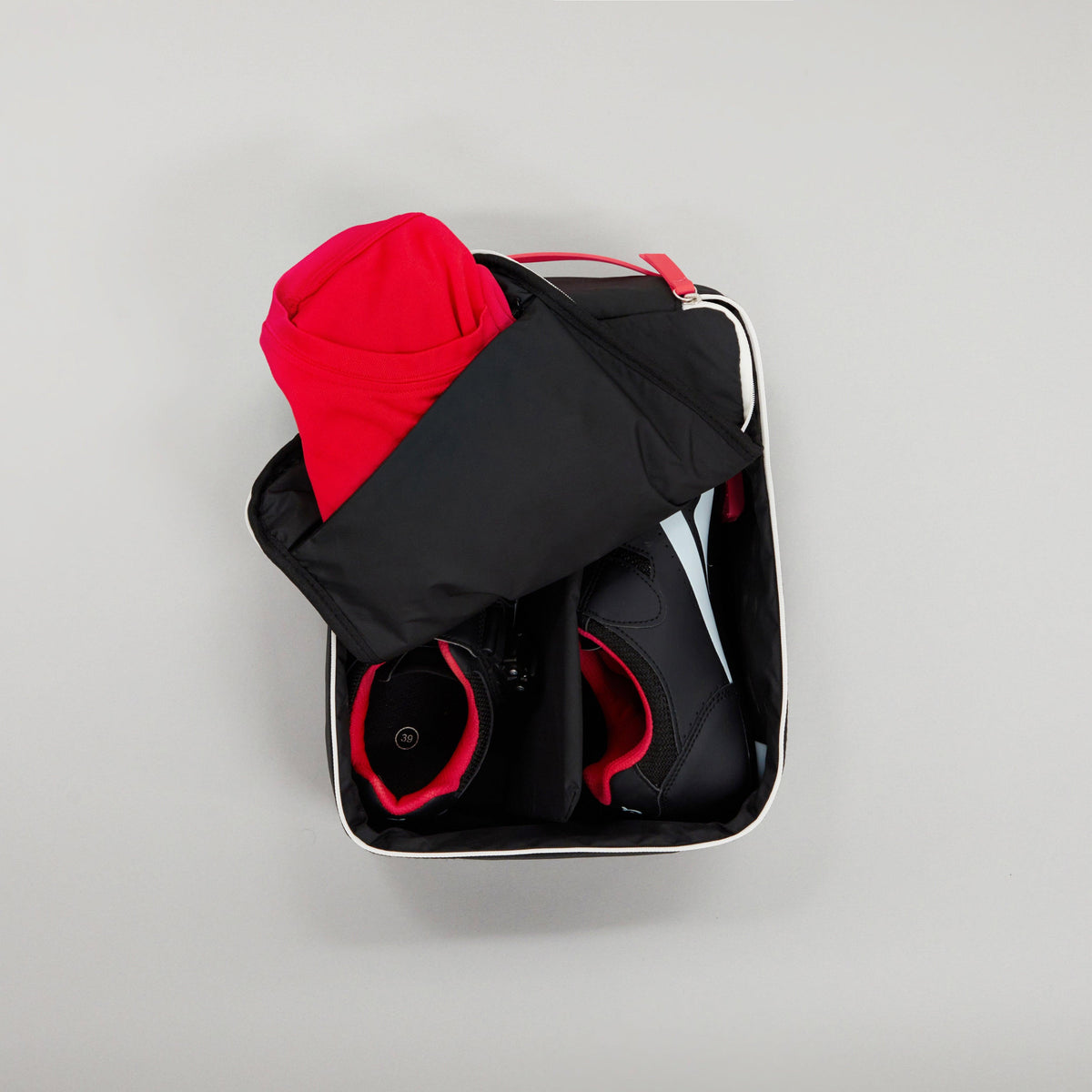 Large Shoe carry in Ink / White / Red colourway unzipped showing shoes inside and socks in the inner pocket 