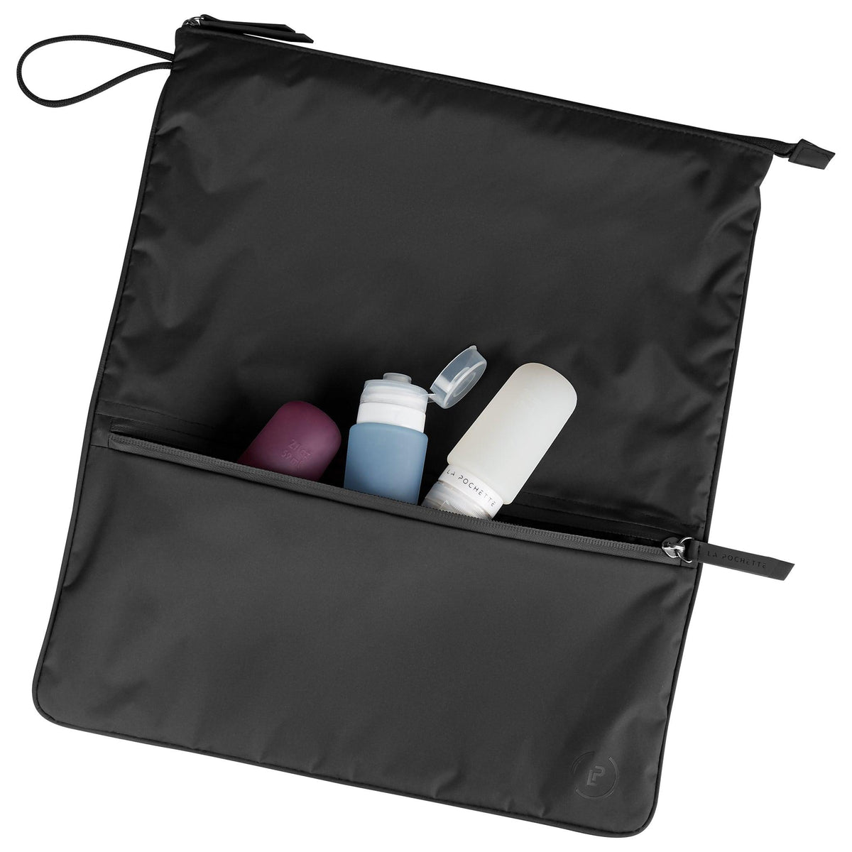Ink Sweat Bag laid flat, topped with a small La Pochette Anywhere Everything Bag holding La Pochette silicone travel bottles.