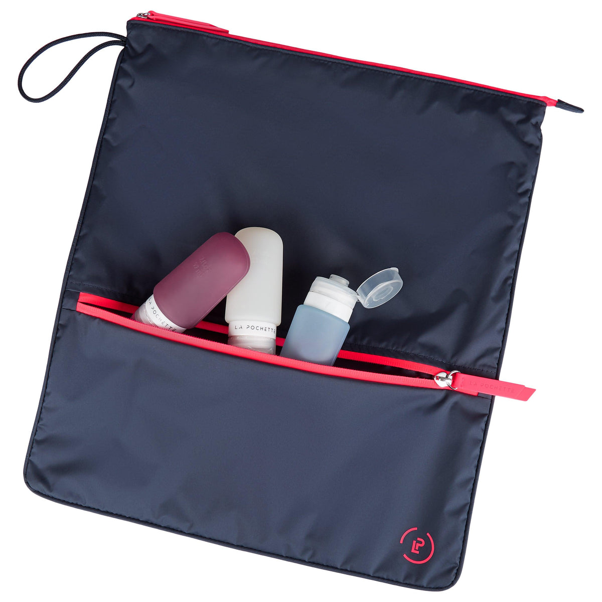Midnight Neon Pink Sweat Bag, shown flat and with two La Pochette silicone travel bottles resting on top and in front pocket