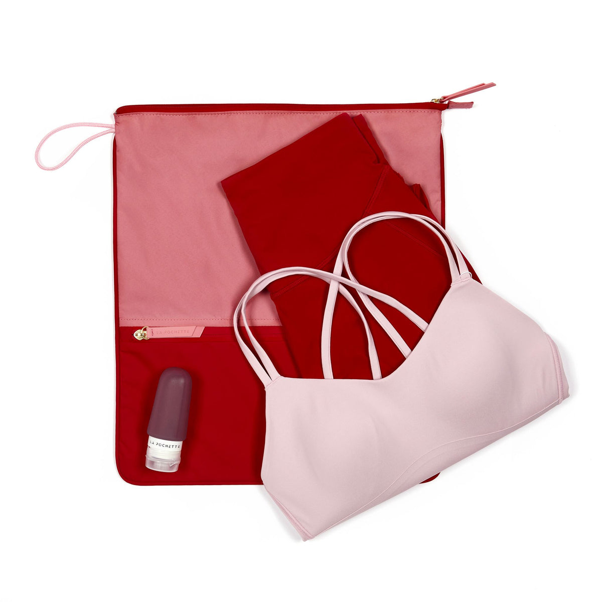 Peony and chilli Sweat Bag shown flat, with folded gym clothes and La Pochette silicone travel bottles