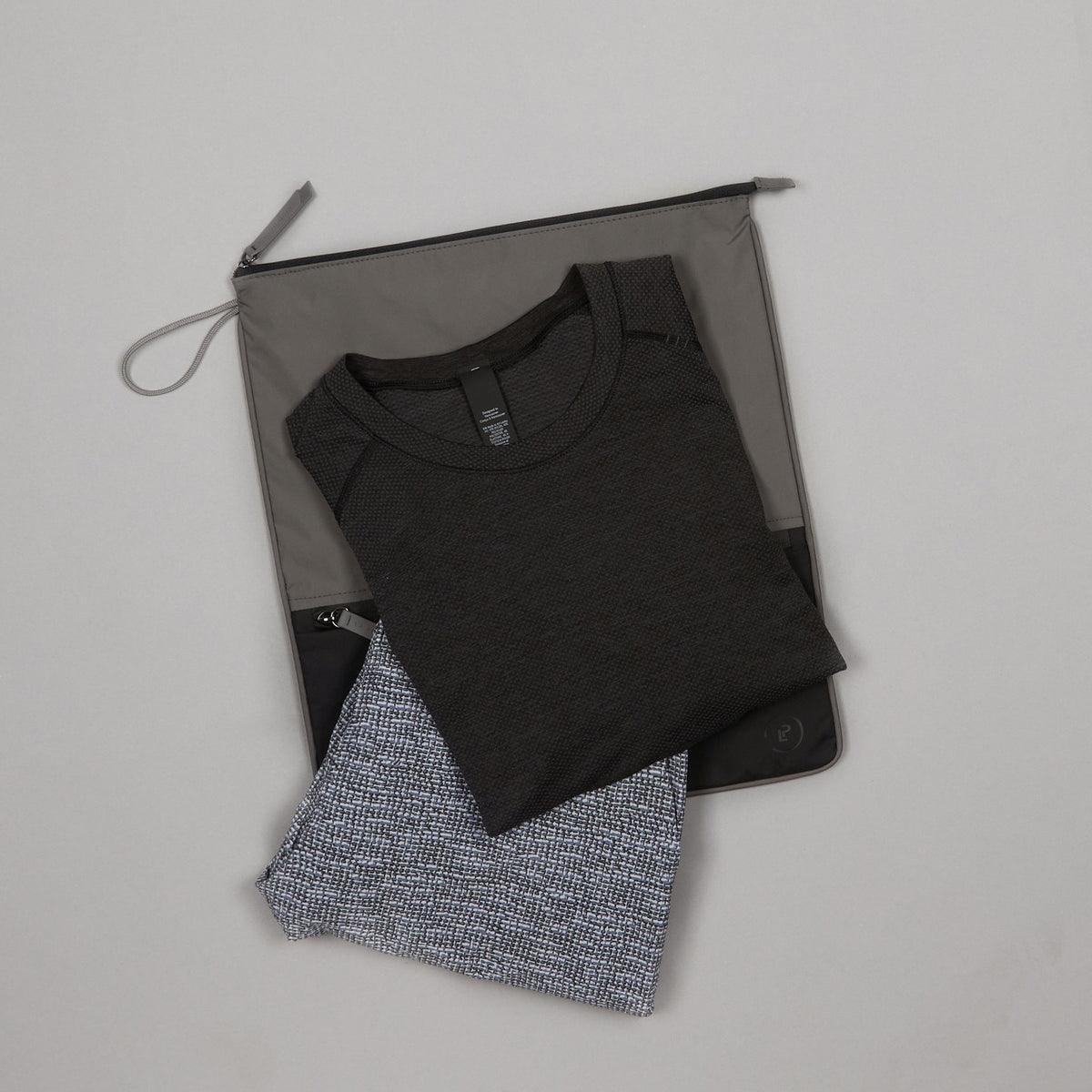 Pewter Ink Sweat Bag shown flat, with folded gym clothes