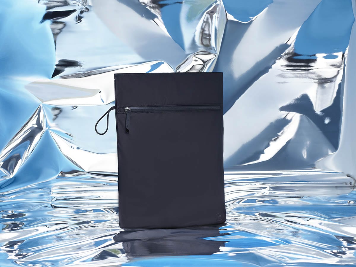 Kit Bag in black on a blue mirrored abstract backdrop