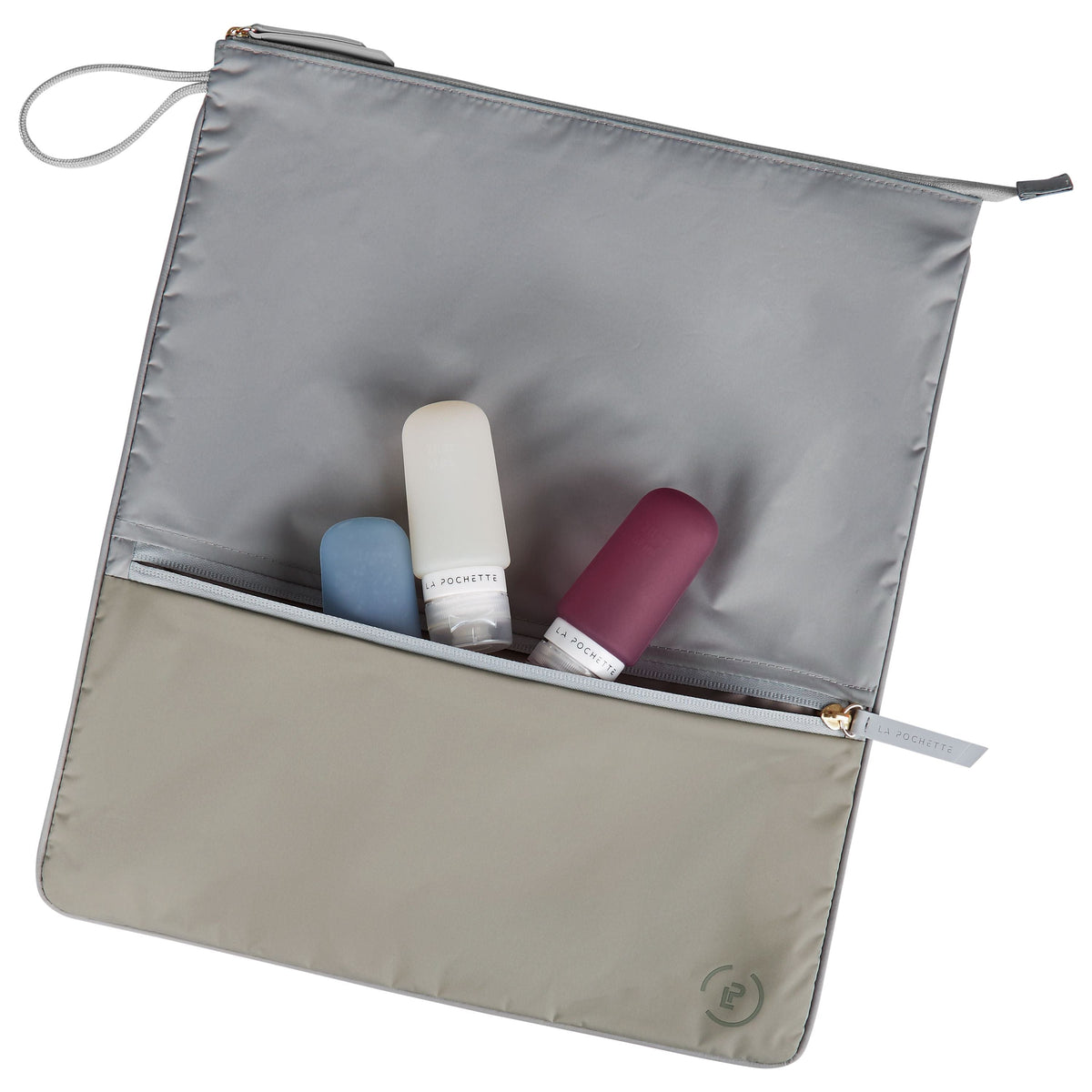 Grey and light beige Sweat Bag laid flat, with La Pochette silicone travel bottles on top and inside the front pocket