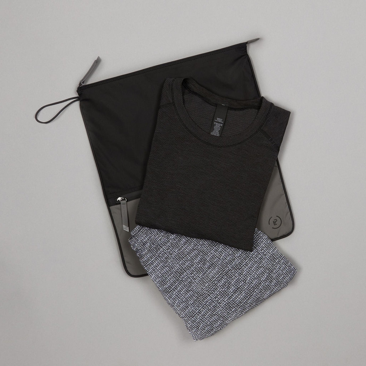 Sweat Bag shown with gym tops - lightweight bag for storing clean or dirty gym kit