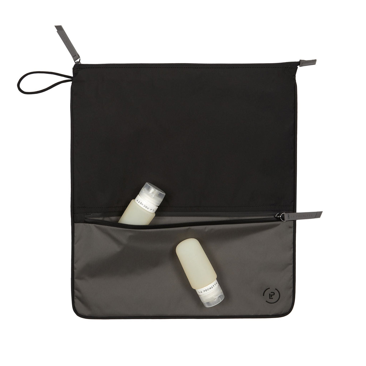 Sweat Bag in dark grey and black shown with two La pochette travel bottles 