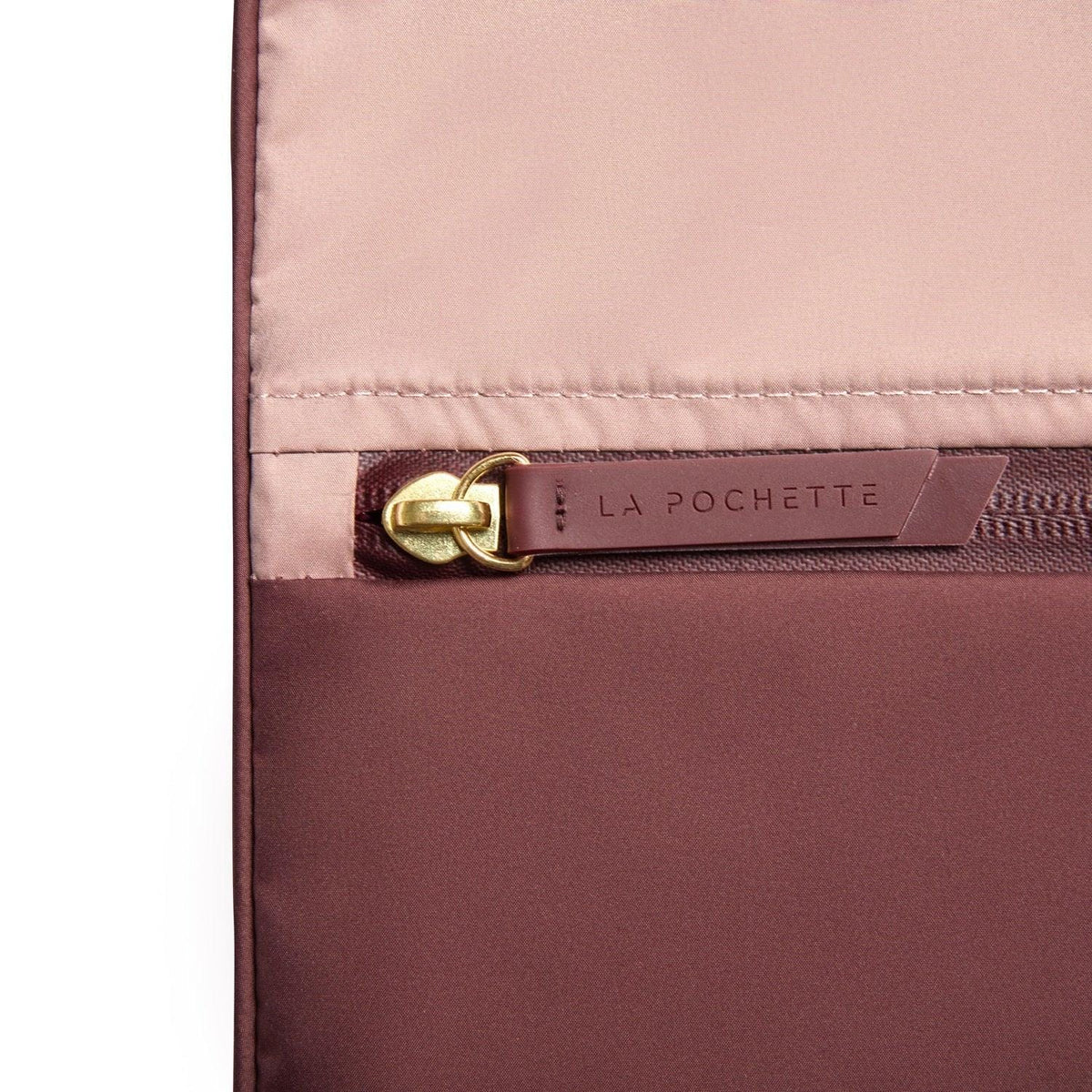 Close-up of Burgundy Sweat Bag showing the La Pochette logo detail in soft pink